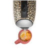 Beige leopard print electric kettle pouring hot water into a coral mug