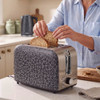 Two croissants in a black and silver two-slice toaster with bun warmer