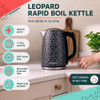 Black leopard print kettle being filled with water at kitchen sink