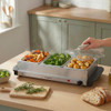 Progress buffet server with roasted vegetables and potatoes in kitchen setting