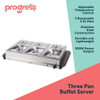 Three-compartment buffet server with roasted turkey, potatoes, stuffing, and vegetables, set for Christmas dinner.