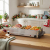 Silver three-compartment buffet server with lids, shown on kitchen worktop