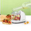 White Progress food processor with diced vegetables, bottle pouring oil, two slices of bruschetta nearby