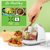 Food processor with feeding chute shown adding olive oil to chopped vegetables.