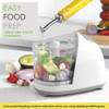 Food processor with feeding chute shown adding olive oil to chopped vegetables.