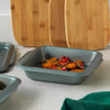 Square non-stick roasting tin with handles, shown with roasted vegetables.