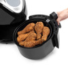 Fried chicken and waffles served with blueberries, promoting healthier frying.