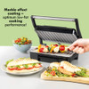 Electric grill with marble effect coating, shown cooking chicken skewers, alongside salad and panini.