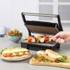 Countertop grill with chicken and vegetable skewers, toasted paninis, and salad.