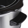 Close-up of stainless steel slow cooker with black handle and rim