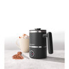 Black electric milk frother with Progress branding beside hot chocolate and grated chocolate.