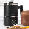 Black electric milk frother with Progress logo next to a glass of hot chocolate and toppings.