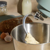 Teal stand mixer with stainless steel bowl, shown from the side