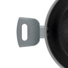 Black frying pan interior, close-up showing pouring spout and non-stick surface