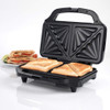 Electric sandwich maker with non-stick plates, showing toasted sandwiches inside.