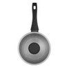 Set of black saucepans and frying pans with lids, shown in a modern kitchen