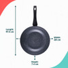 Set of non-stick black pans with cooked food and fresh tomatoes on white surface