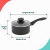 Set of three black saucepans with glass lids, shown on a kitchen counter with food inside.