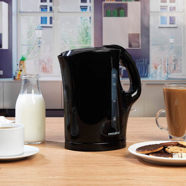 Black electric kettle with two cups of tea and lemon slices, shown on white background.