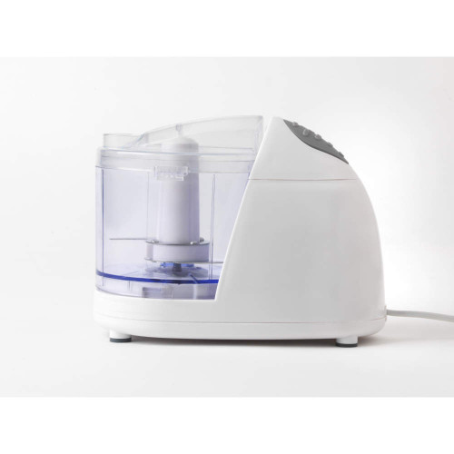 Mini food chopper with clear bowl, filled with fresh chopped vegetables, beside bruschetta slices