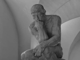 Frequently Asked Questions about Healthiest Mushrooms: An image of 'The Thinker' statue symbolizing contemplation and answers to common queries