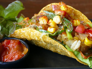 Image of Delicious vegan tacos filled with Lion's Mane mushrooms, topped with fresh cilantro and served on a bed of lettuce