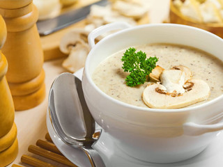 A bowl of hearty wine cap mushroom soup, with chunks of mushrooms, carrots, and onions in a flavorful broth."