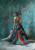 Fantasy fashion portrait with ornate corset dress, floral hat and long flowing train