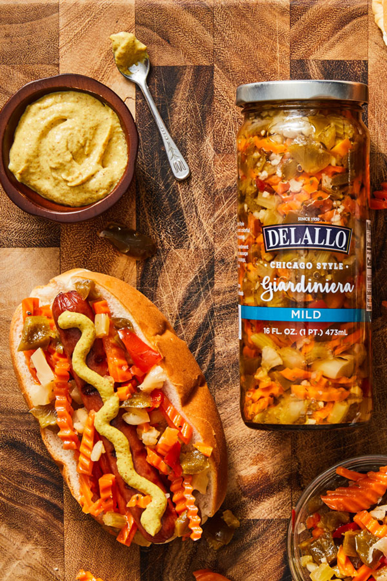 Grilled hot dog on a bun topped with giardiniera and mustard