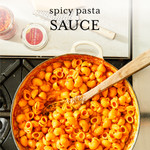 Prepared pasta with red sauce in a pot on a stove Prepared pasta with red sauce in a pot on a stove