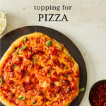 Baked pizza with red sauce and topped with cheese and chopped calabrian chili peppers Baked pizza with red sauce and topped with cheese and chopped calabrian chili peppers