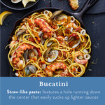 Bucatini pasta with assorted seafood prepared in a cast iron skillet