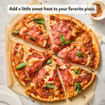 Baked pizza with hot honey sauce, cheese and basil