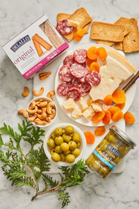 Assorted DeLallo charcuterie items arranged on a marble table