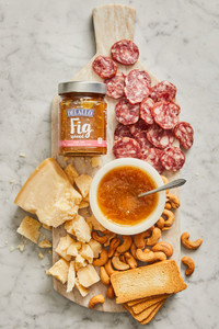 Assorted DeLallo charcuterie products arranged on a marble table