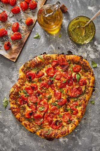 https://cdn11.bigcommerce.com/s-cjh14ahqln/images/stencil/500x500/uploaded_images/pizza-with-cherry-tomatoes-and-pesto-web.jpg?t=1655303197