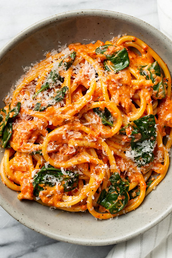 Pasta and spinach with a creamy red sauce.