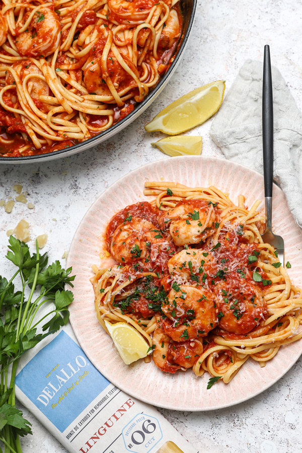 Shrimp is a spicy tomato sauce with parsley and linguine.