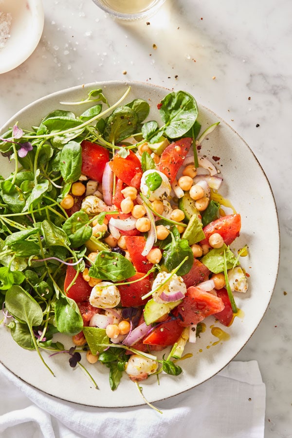 Image of Avocado and Chickpea Salad with spring greens and fresh mozzearella