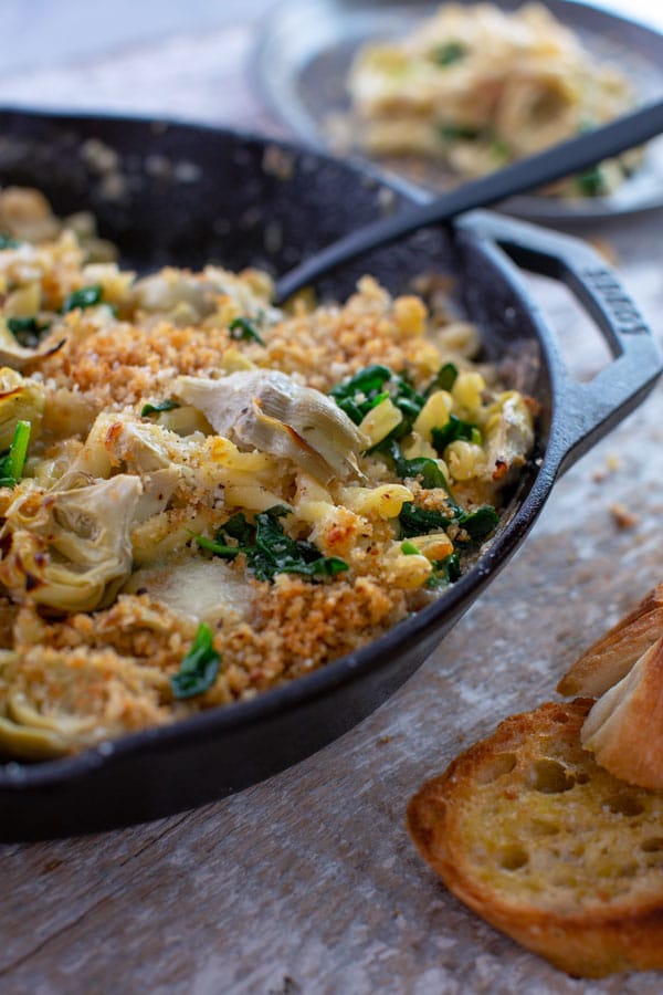 Image of baked pasta with spinach. artichokes. and brie