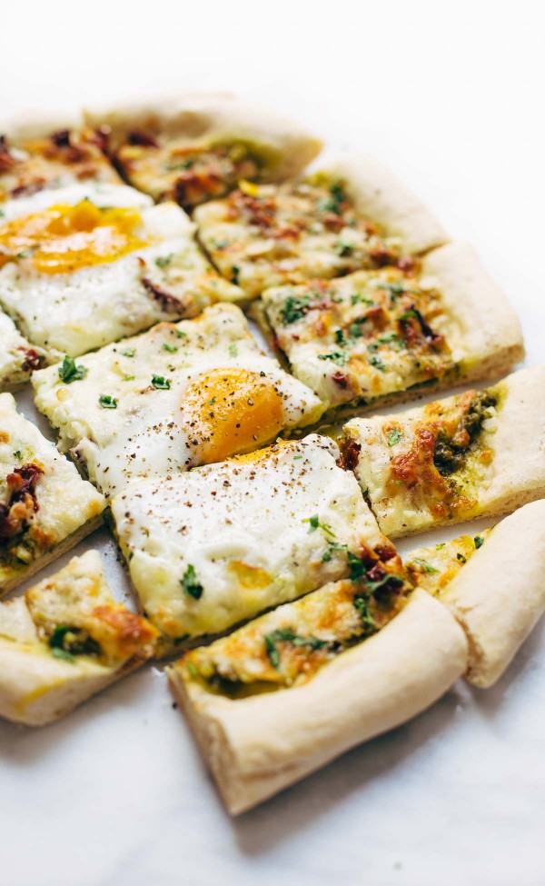 finished pizza topped with eggs and sliced into pieces