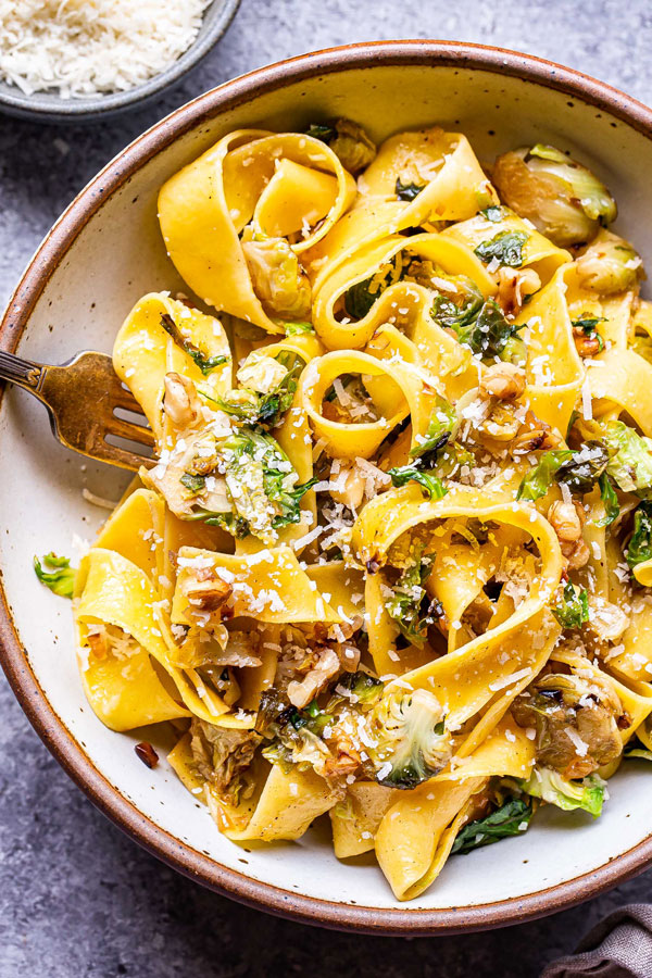 Pasta pictured with cheese and cooked brussel sprouts