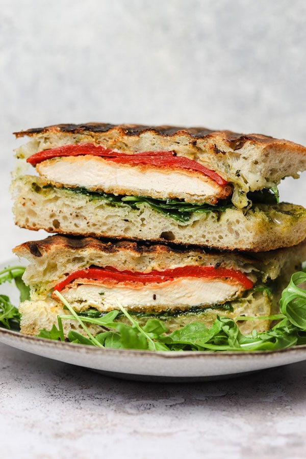 Chicken pesto panini pictured on a white plate