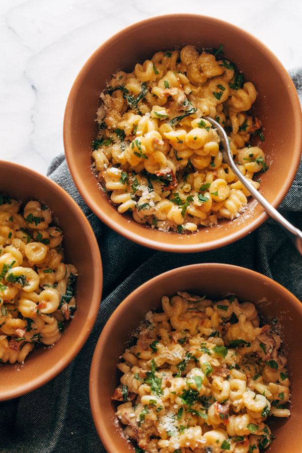 3 bowls of pasta in a creamy cheesy sauce with sun-dried tomatoes