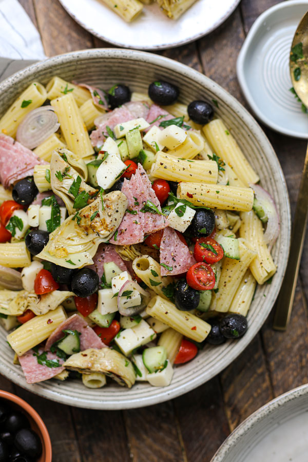 Pasta mixed with salami, olives, and tomatoes