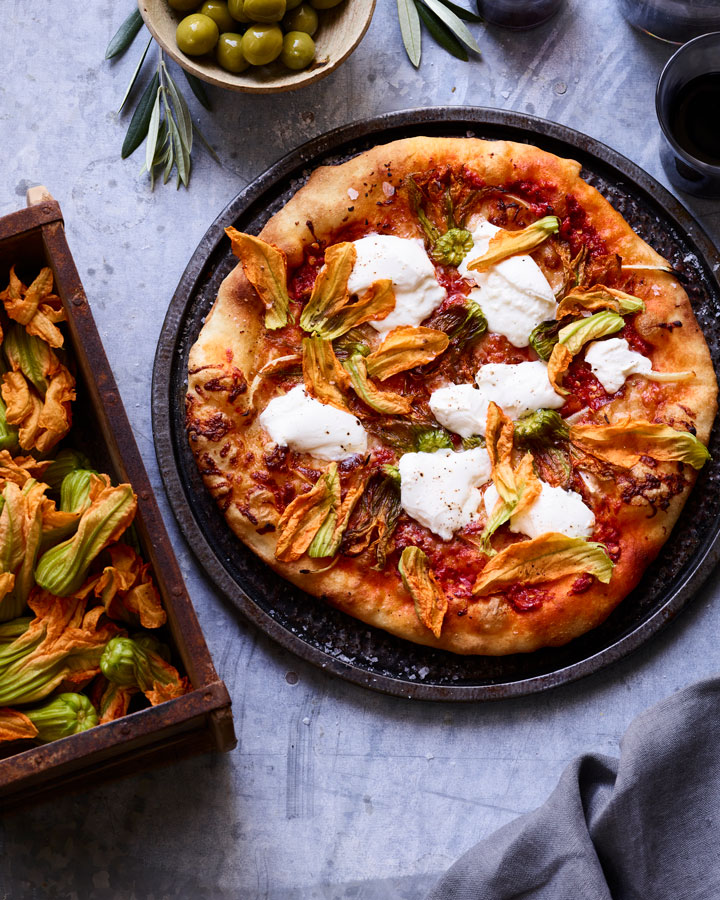 finished pizza with squash blossoms and burrata