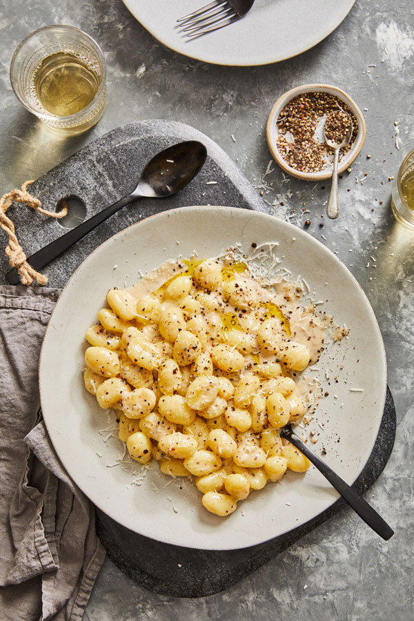 Potato gnocchi with a creamy cheese sauce and black pepper on a plate