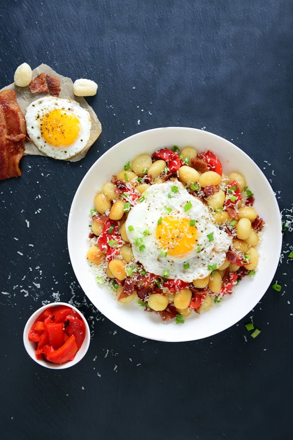 Gnocchi and pepper with an egg in a white plate