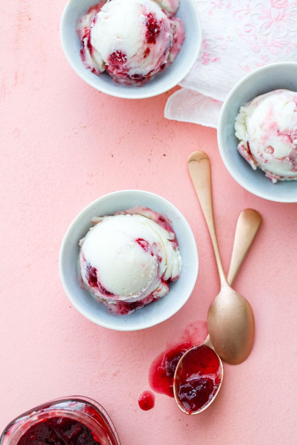 Frozen yogurt with cherry spread in white bowl 