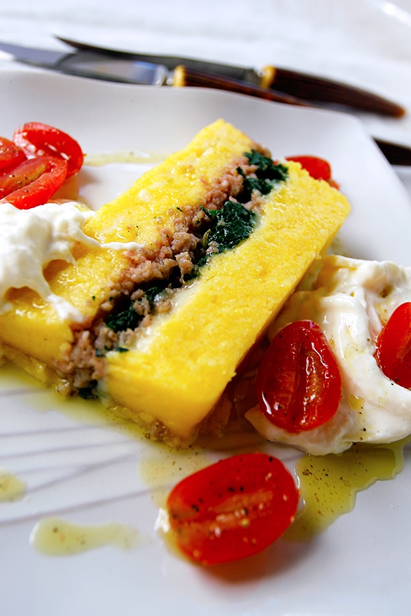 layered polenta with sausage and spinach inside 